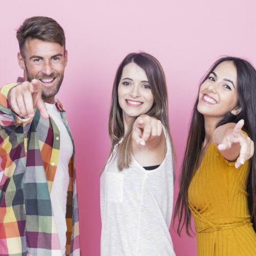 group-happy-friends-pointing-their-fingers-pink-background